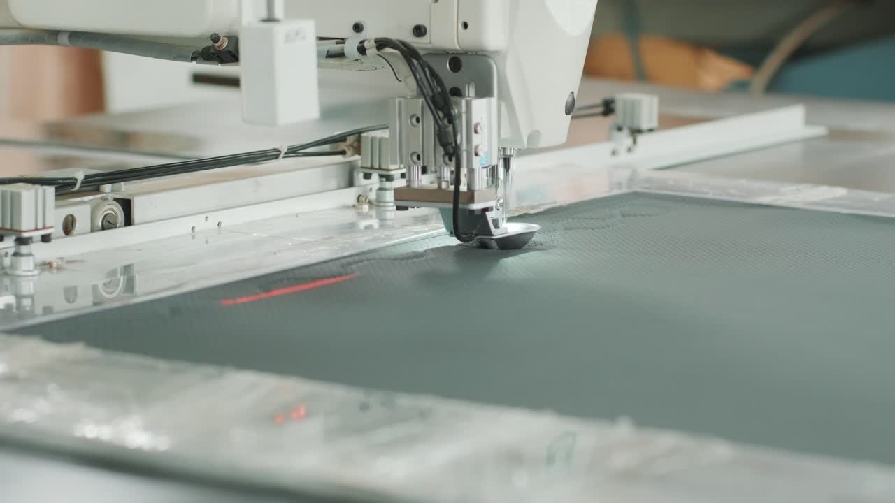 Closeup of sewing machine working part with leather. Cnc sewing machine