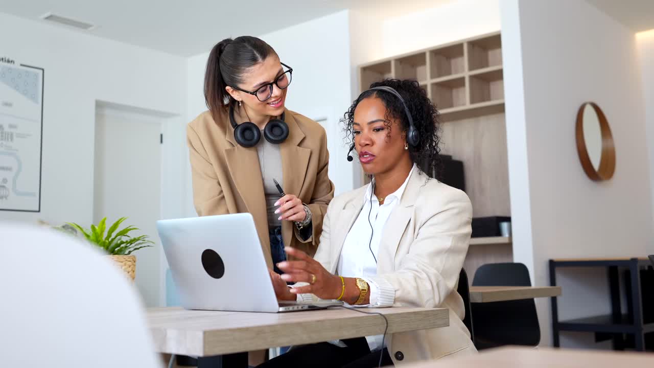 Two businesswomen collaborating in an office setting