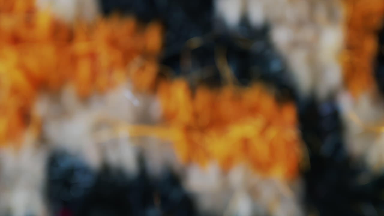 Close up view of woven wool fibers in warm yellow and black tones