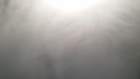 Slow-motion-fog-and-smoke-moving-across-textured-surface,-perfect-for-eerie,-scary-and-mysterious-atmosphere-presentations