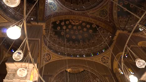 mosque of muhammad ali interior illuminated chandelier ceiling with painting of arab muslim in arch