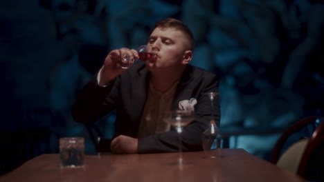 man drinking wine in a restaurant