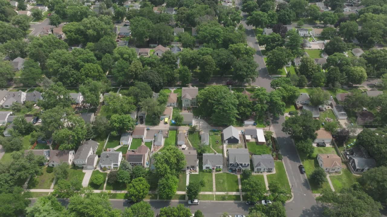 Aerial view of a green suburban neighborhood with houses and streets