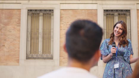 female tour guide addressing a group of tourists