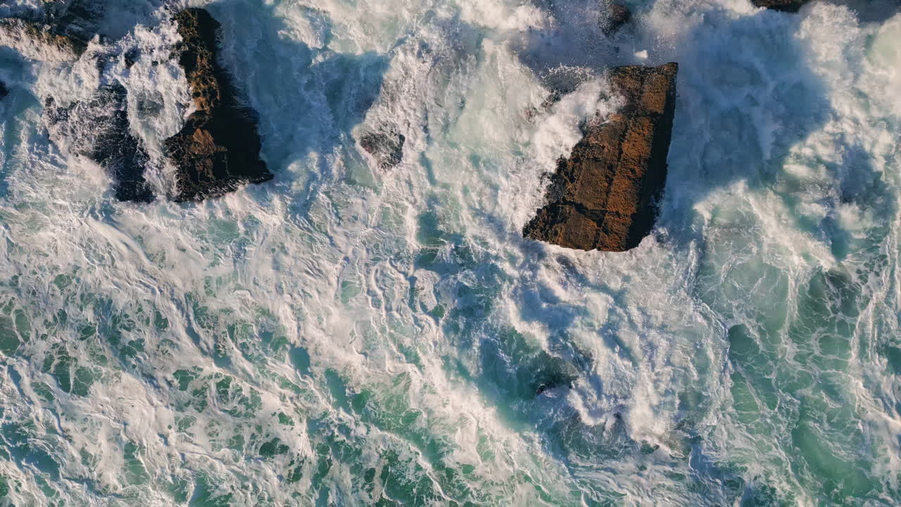 Foaming sea crashing cliff slow motion. Aerial view foamy water splashing shore