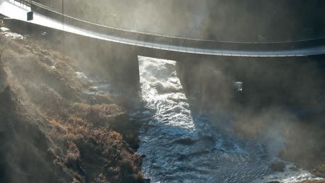 a turbulent stream rushes under the road bridge near the skjervfossen waterfall