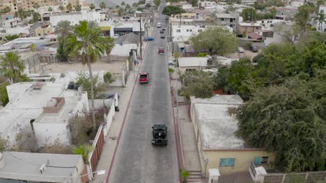 aerial follow of suv on streets of el medano, cabo san lucas, mexico