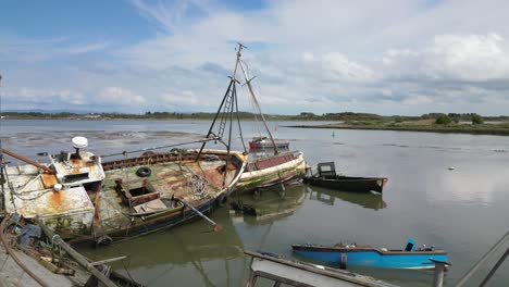 Rusted-shipwrecks-in-calm-water-of-River-Wyre-at-Fleetwood-Docks-Lancashire-UK