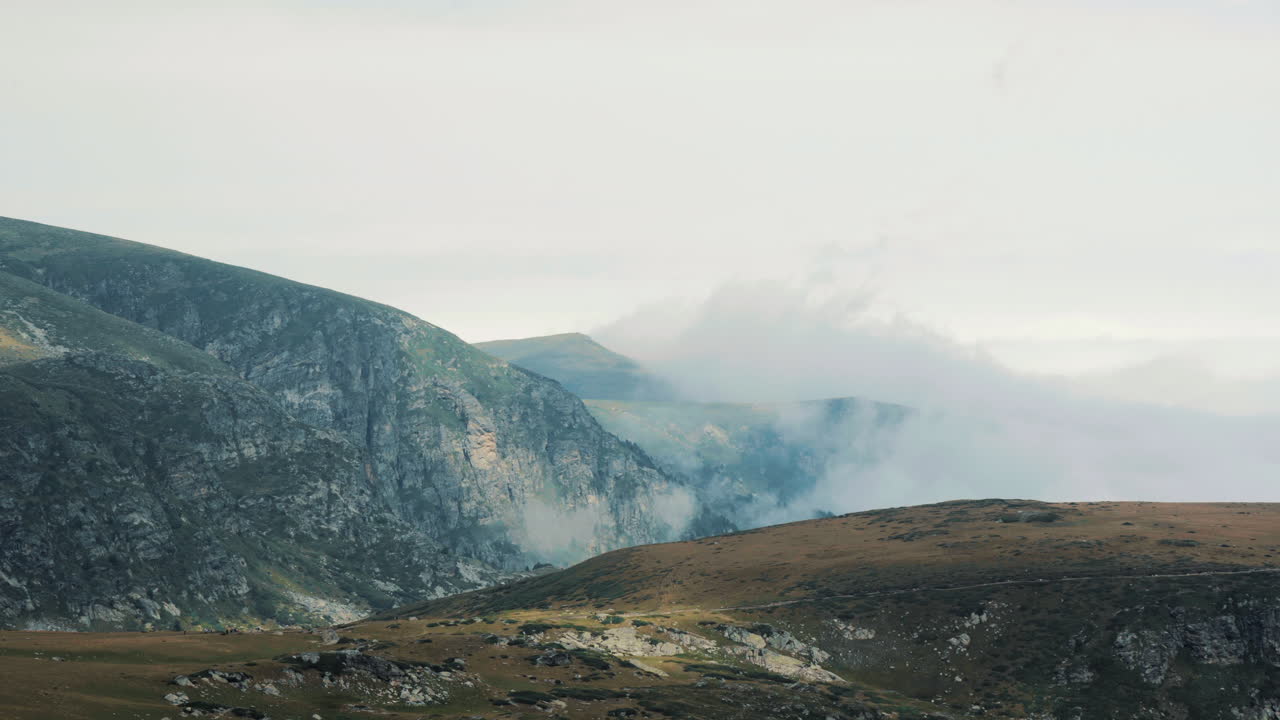 Peaks covered by low clouds near the meadow where the ritual dance paneurhythmy is played. Located near the Rila Lakes in the Rila Mountains, Bulgaria