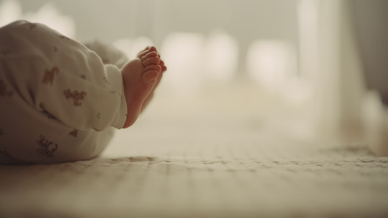 Mother Touching Newborn's Feet Symbolizing Motherhood