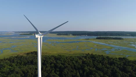 ocean with a windmill, and a marsh filmed with a drone