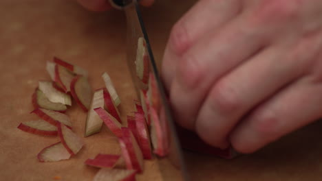 Hands-Chopping-Long-Scarley-Radish-On-Wooden-Board