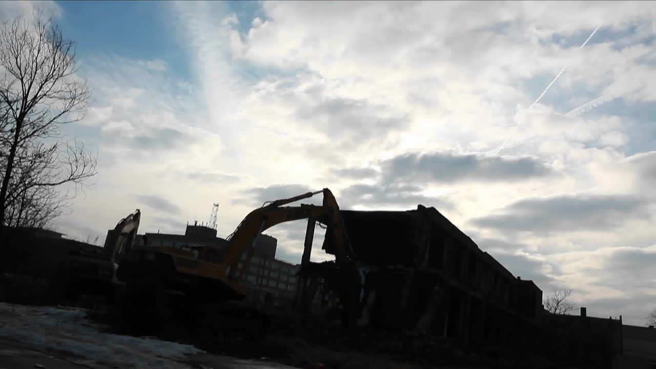 A bulldozer equipment is clearing materials from one place to another