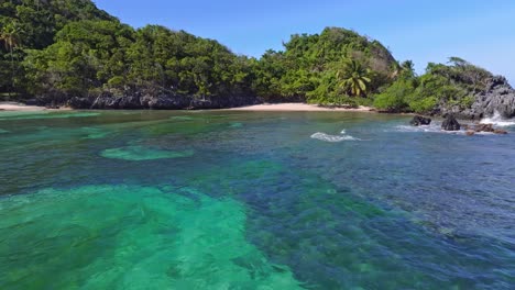 Clear-Blue-Sea-Water-Of-Playa-Ermitaño-Beach-In-Dominican-Republic---Drone-Pullback