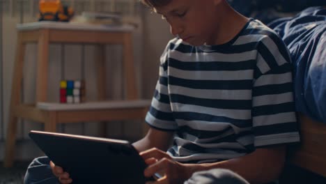 child using tablet in their bedroom