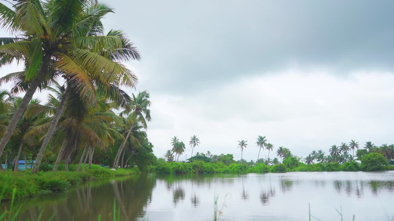 A place where fish farming was done which was submerged due to rain , Heavy rains due to climate change , Many nearby coconut groves are standing in water ,Flash floods , Ready to rain