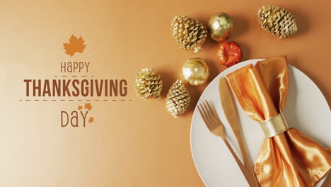 animation of happy thanksgiving day text over decorations and place setting