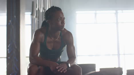 resting after workout, woman in gym wearing sportswear and looking determined, copy space