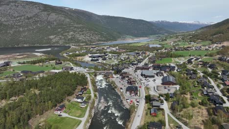 otta waterways in background with fossbergom town and bovra river seen in foreground - springtime aerial norway