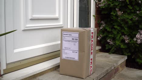 male courier placing parcel on doorstep