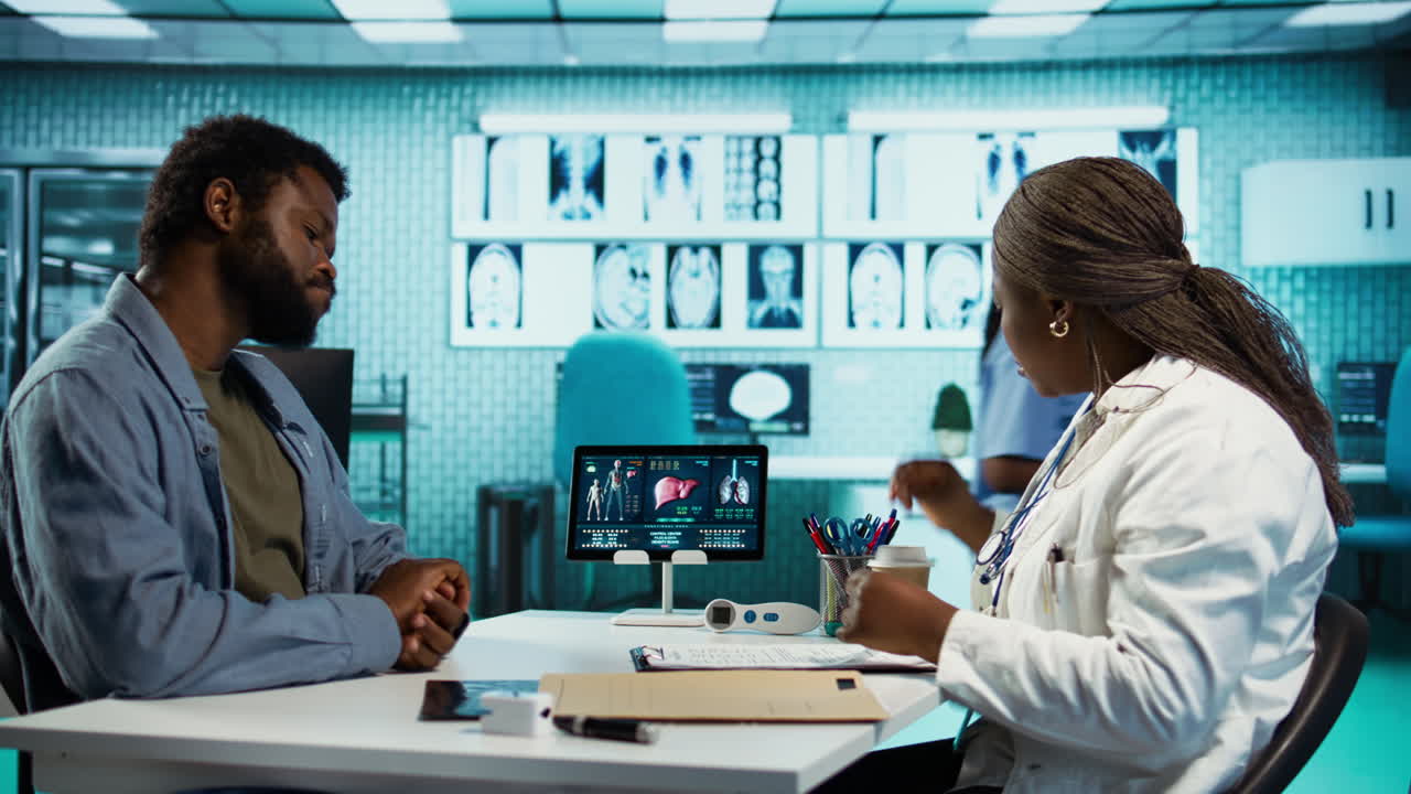 Medic takes notes during routine checkup visit with young man