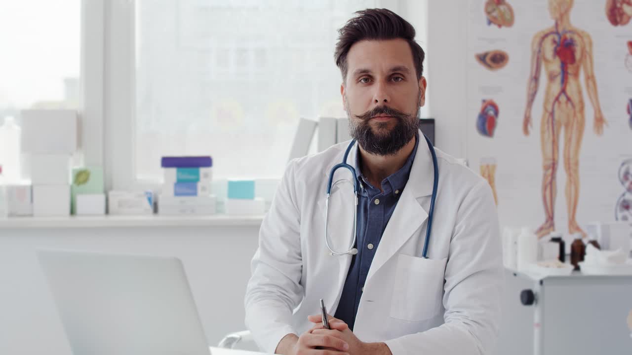 Handheld video shows of male doctor in doctor&rsquo;s office