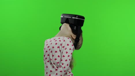 child girl using vr headset helmet to play game. watching virtual reality 3d 360 video. chroma key