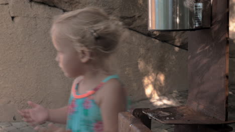 little girl sanitizing hands outdoor