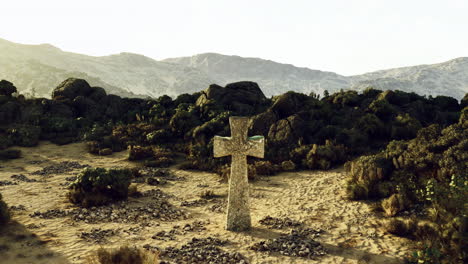 Enigmatic stone cross stands amidst rugged terrain at sunset