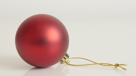 red bauble with golden color string slow tilt 4k