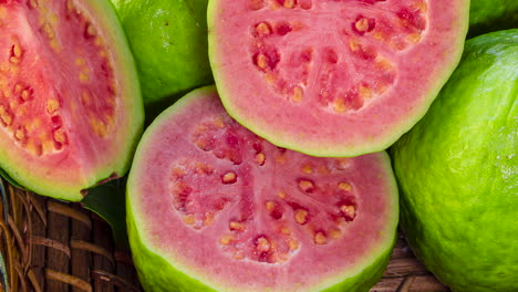 closeup on red guavas cut in basket