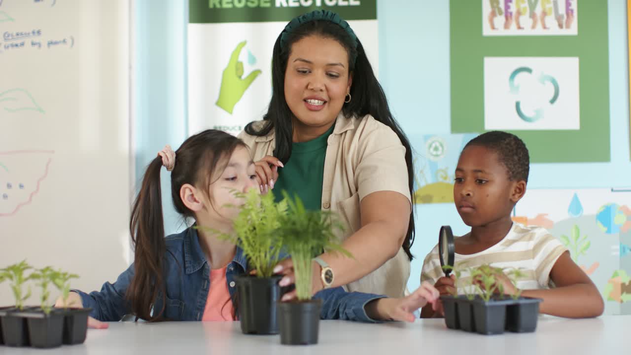 Diverse teacher holding seed and guiding kids, examining seedling with lens at table about plants