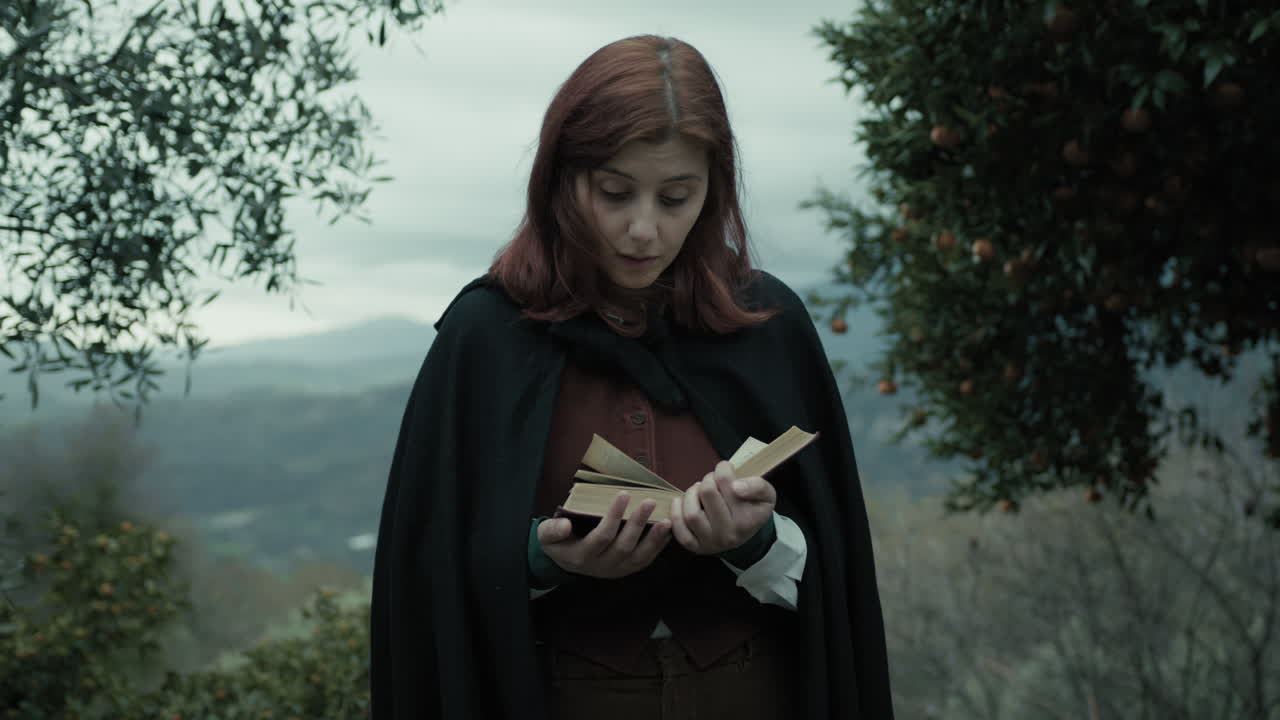 Young Woman Reads A Twist In The Story Of Her Novel Book In Mountains