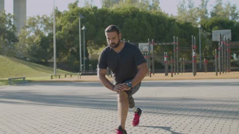 muscular man with disability doing stretching exercises.