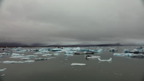 melting ice and icebergs in glacial lake in iceland