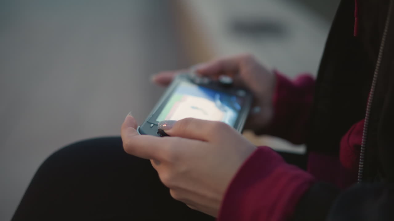 Focused Hands With Glowing Screen, Closeup Of Hands On Controller With Illuminated Display Near Water, Detailed View Of Hands Holding Gaming Device With Bright Screen Near Evening Water Scene