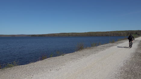 man riding a bike on a dam