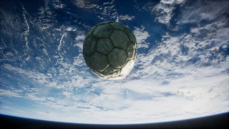 old soccer ball in space on earth orbit