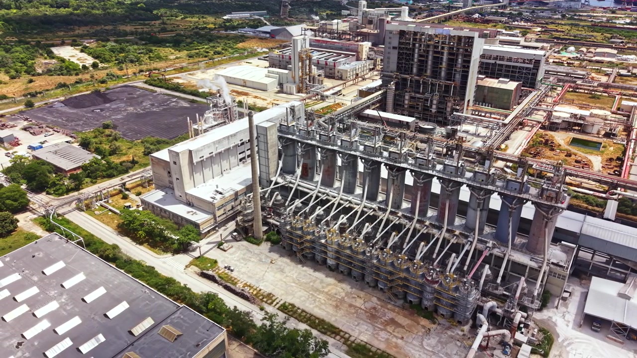 Large industrial facility with multiple structures and equipment in a manufacturing plant during daylight