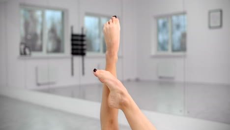 Woman Stretching Legs in a Gym