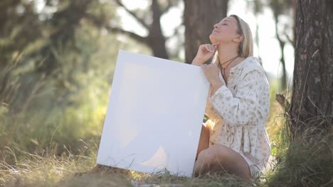 female artist finds joy and inspiration in the natural surroundings looking at a blank canvas placed - female artist finds joy and inspiration in the natural surroundings, looking at a blank canvas placed nearby