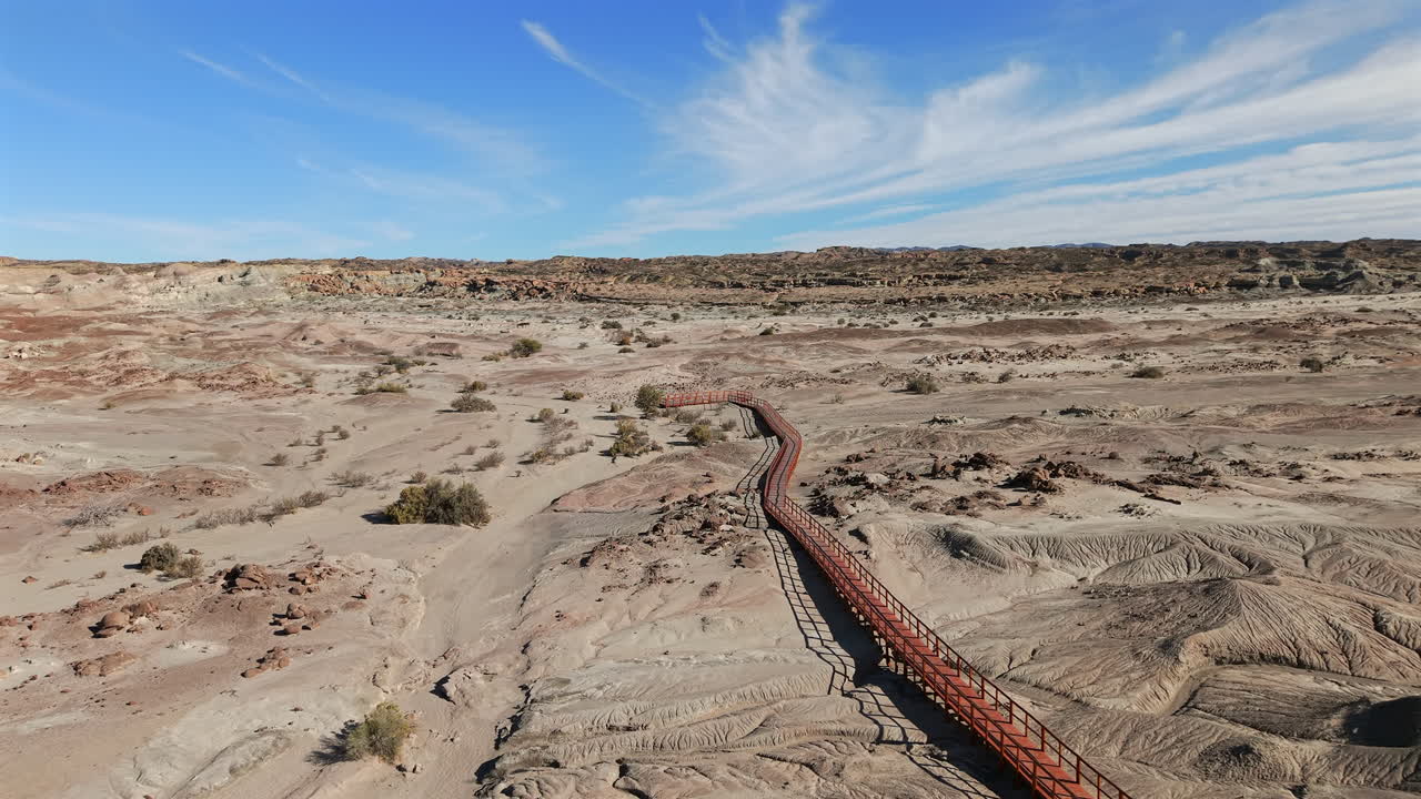 Valle de la Luna, Parque Provincial Ischigualasto, Argentina, showcasing a vast arid landscape with unique geological formations and a long wooden boardwalk for exploration