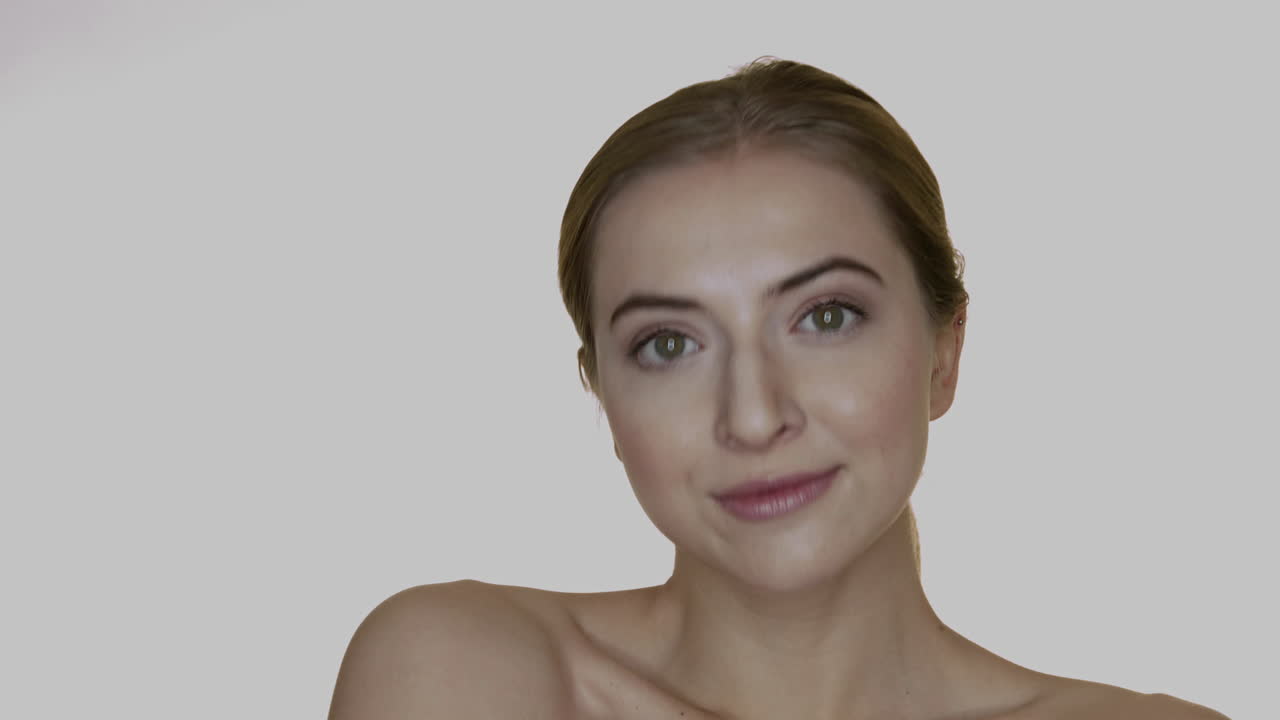 linda mujer natural tocando suavemente su cuerpo y sonriendo a la cámara