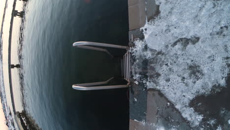 4k-Vertical-shot-of-a-metal-staircase-for-cold-winter-bathing-at-Gothenburg,-Sweden