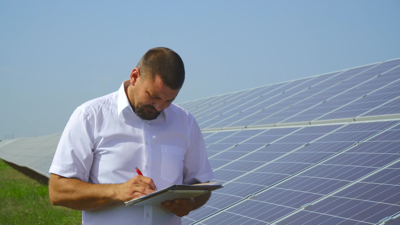Man holding records of solar panels
