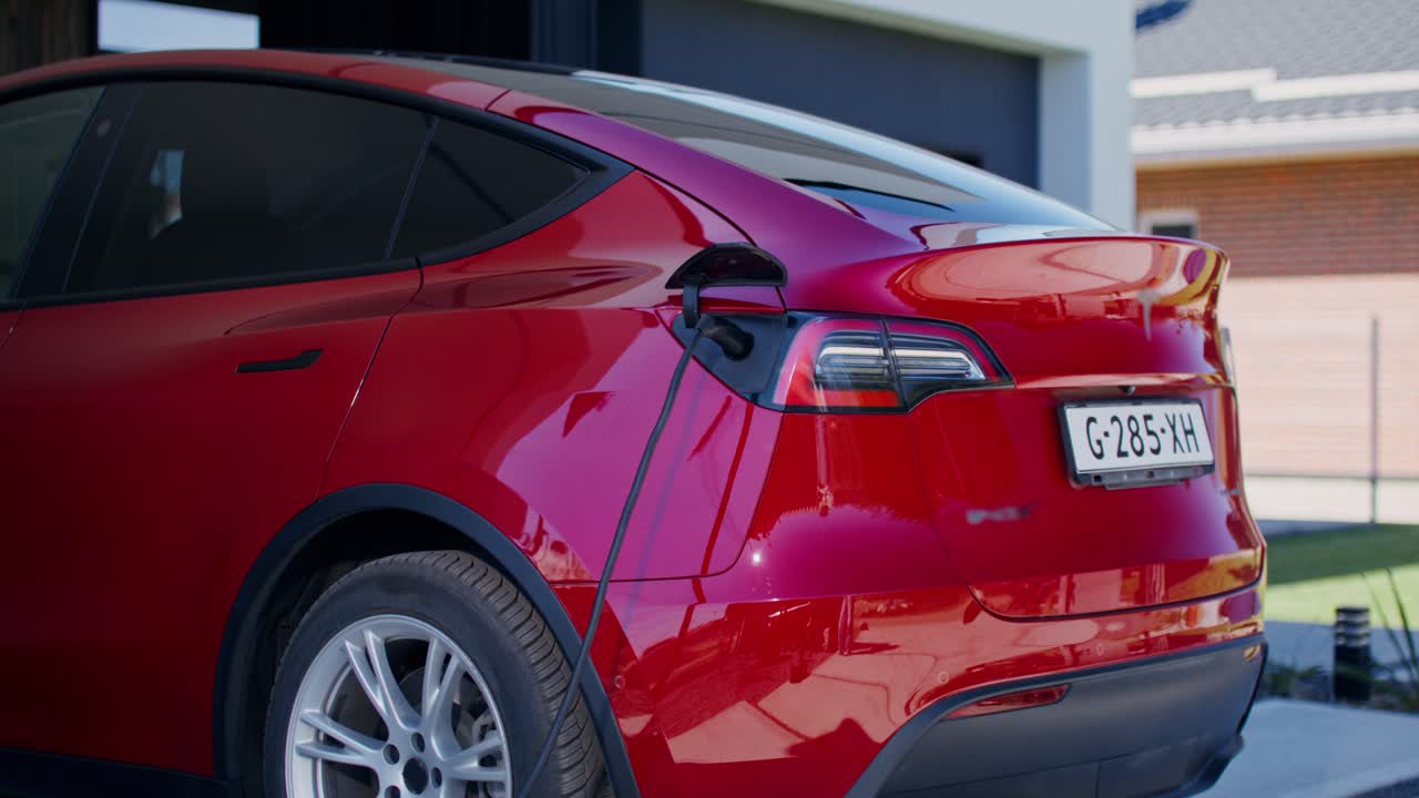 Red Electric Car Charging at Home
