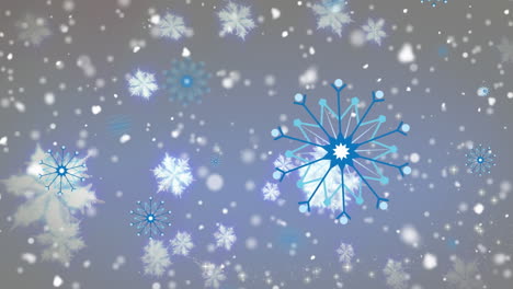 digital animation of snow falling and multiple snowflakes icons floating on blue background