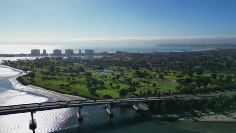 A bright and sunny drone shot capturing Coronado Bridge in San Diego with a smooth view of the coastline.