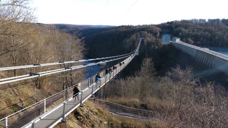 Visitors walking on the longest hanging suspension rope bridge in the world in Harz, Germany