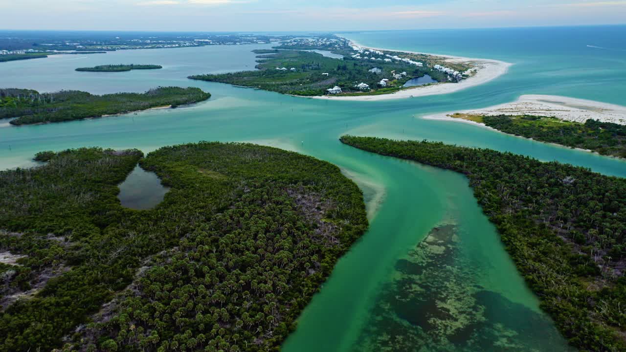 A winding mangrove channel opens into broader teal shallows as the route approaches Stump Pass, framed by barrier islands and the long sandy shoreline of Manasota Key on Florida’s Gulf Coast